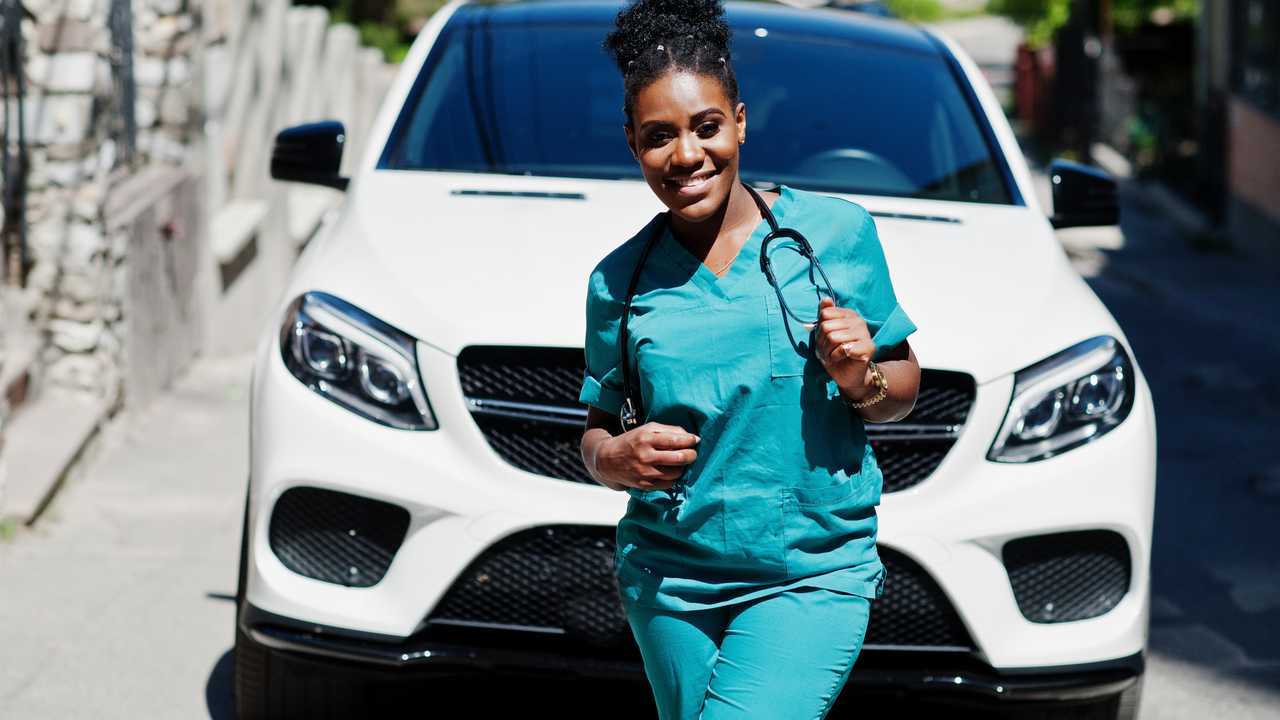 Woman doctor with white suv